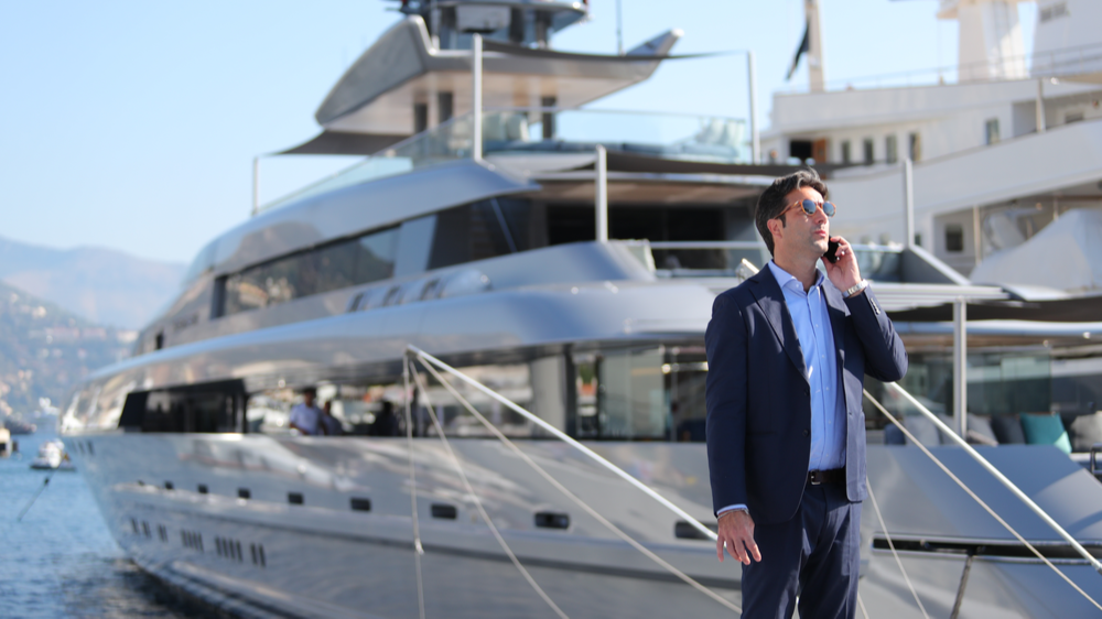 Man discussing price on the phone on the pier